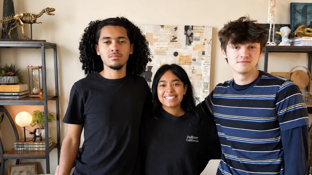 Three Freedom Ave Maria students standing together in a classroom