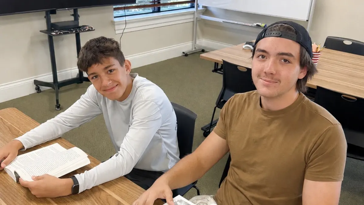 Two Freedom Ave Maria students reading at a classroom table