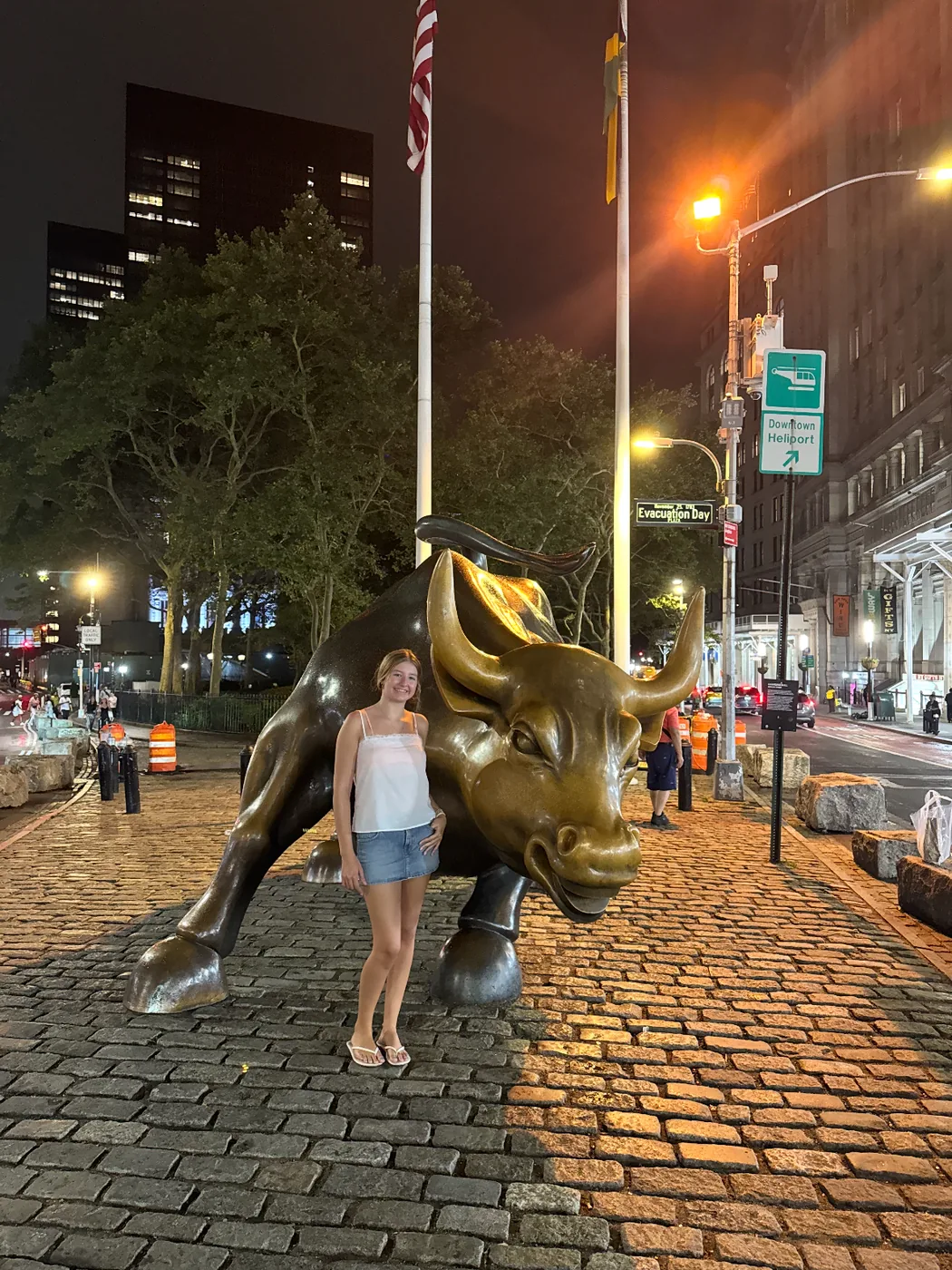Lauren Sharp beside the Charging Bull statue in Lower Manhattan