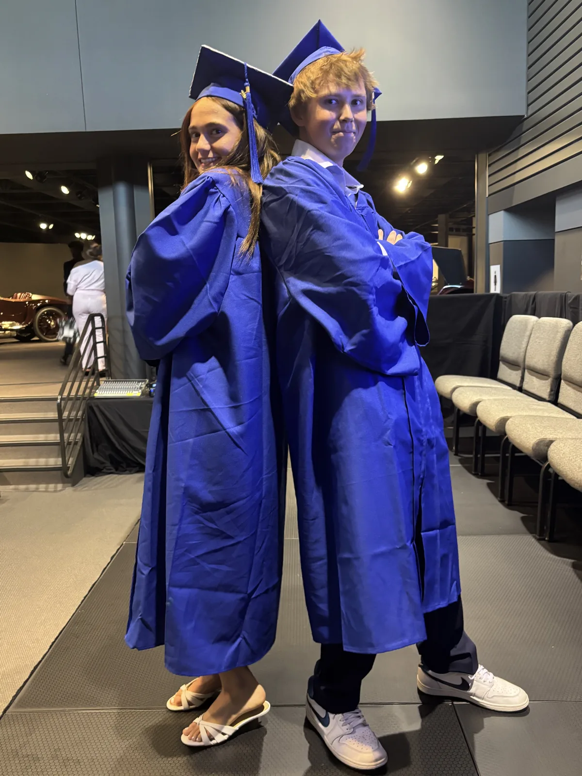 Two Freedom graduates in blue caps and gowns
