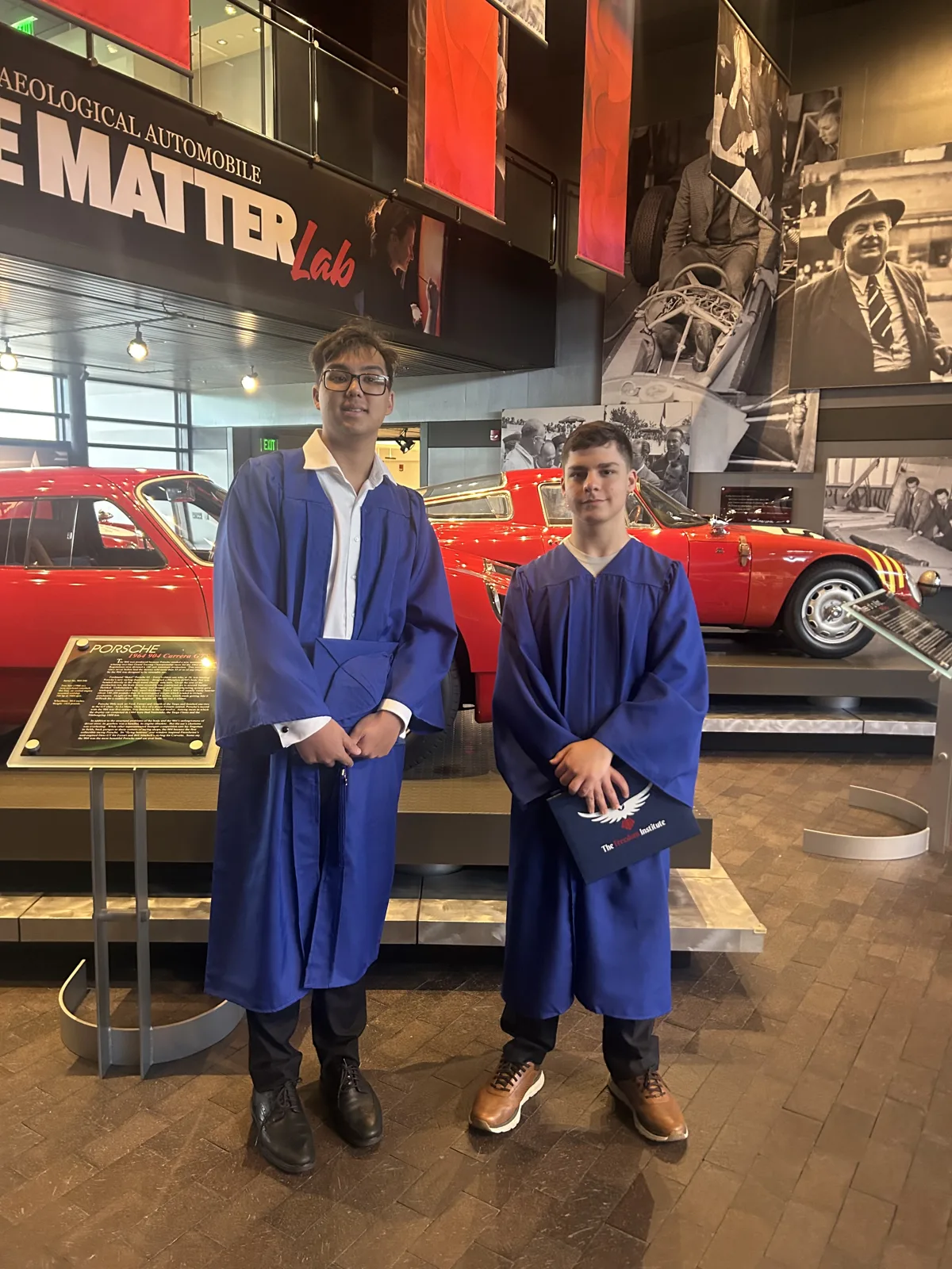 Two graduates in caps and gowns at Revs Institute