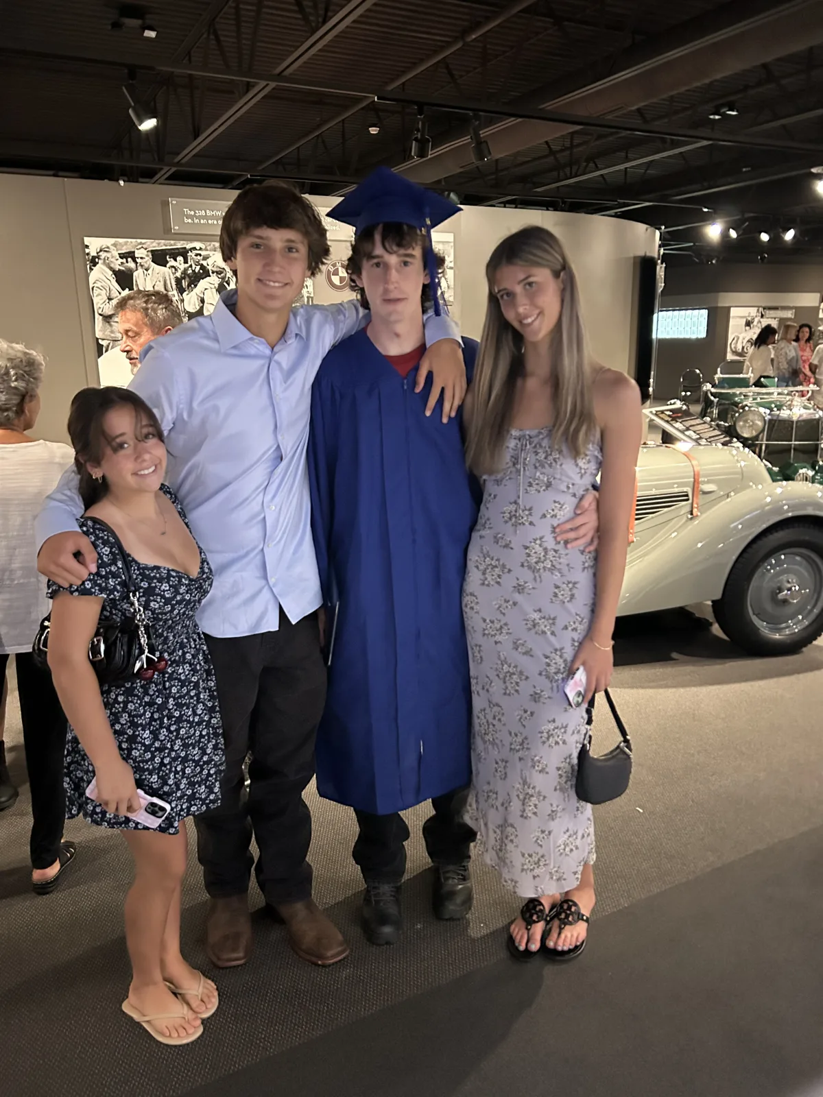 A graduate with family among the classic cars at Revs Institute