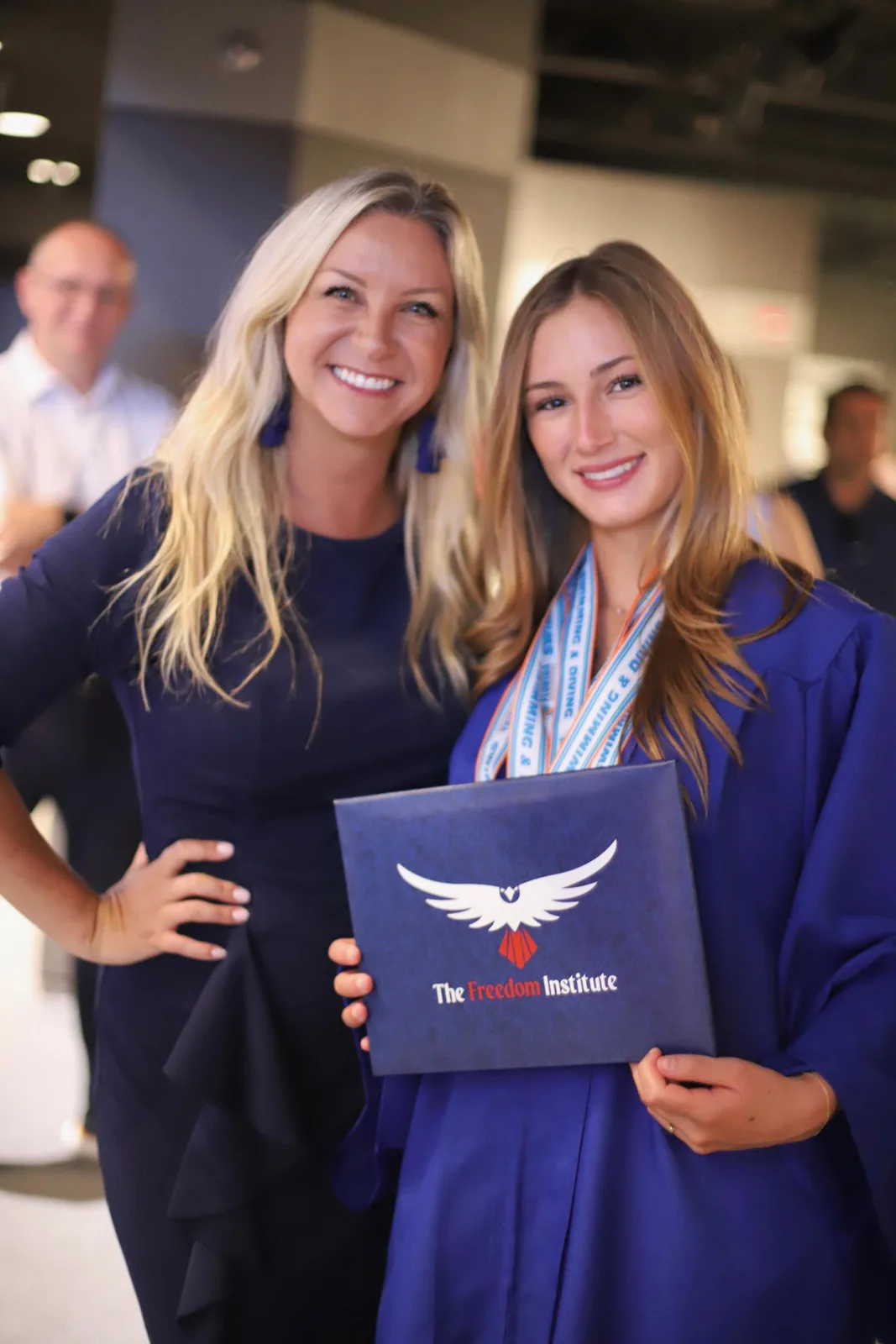 Principal Christy Vaill with graduate Eire Layton holding her diploma