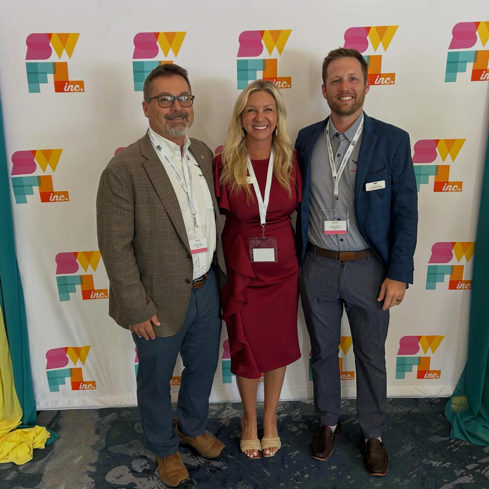 Three Freedom leaders at the SWFL Inc. step-and-repeat