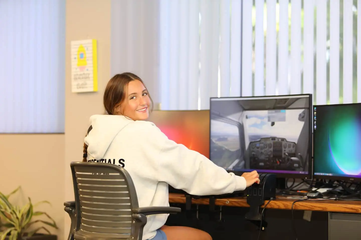 A Freedom Institute student using the flight simulator in the STEAM lab