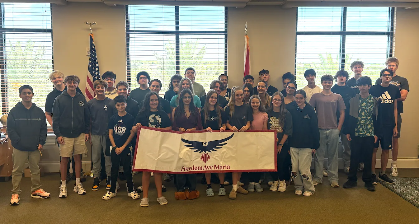 Freedom Ave Maria students holding a Freedom banner