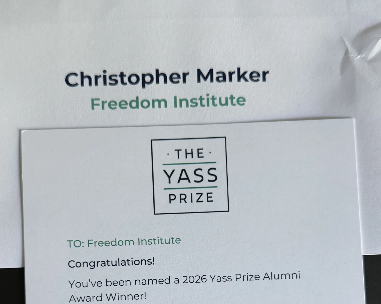 Yass Prize card addressed to Christopher Marker, Freedom Institute: Congratulations! You've been named a 2026 Yass Prize Alumni Award Winner!
