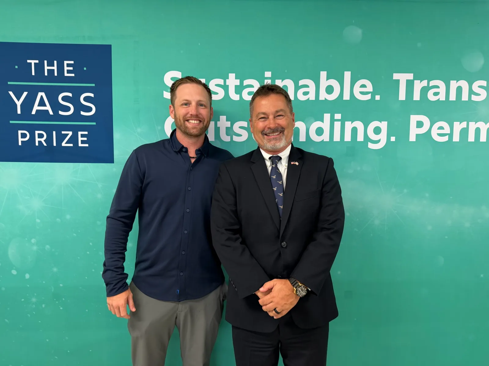 Nathan Poteet and Christopher Marker in front of the Yass Prize backdrop in Philadelphia